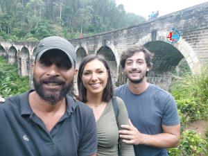 “Tourists enjoying the breathtaking Ella train ride through misty mountains and tea estates in Sri Lanka.”